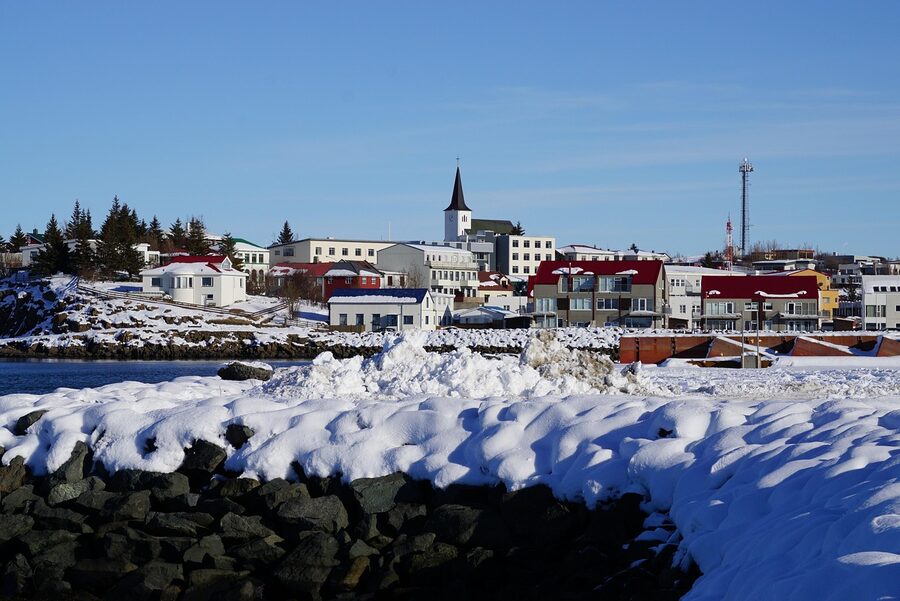 Iceland town under snow in winter with breakwaters
