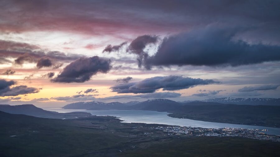 Akureyri rooftops below dramatic clouds at the head of Eyjafjordur fjord