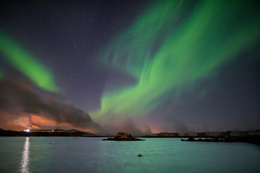 Northern lights reflected in a lake near Keflavík Iceland