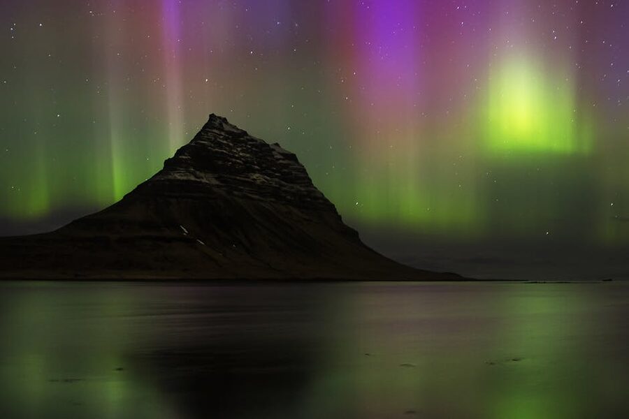 Northern lights over Kirkjufell mountain in winter Iceland