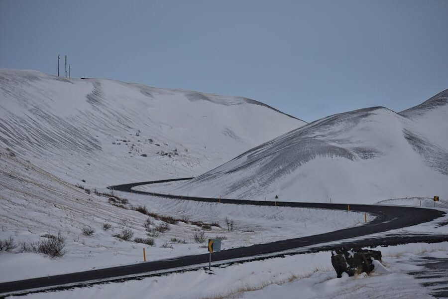 Snow-covered winding road through mountains in Þingeyjarsveit Iceland