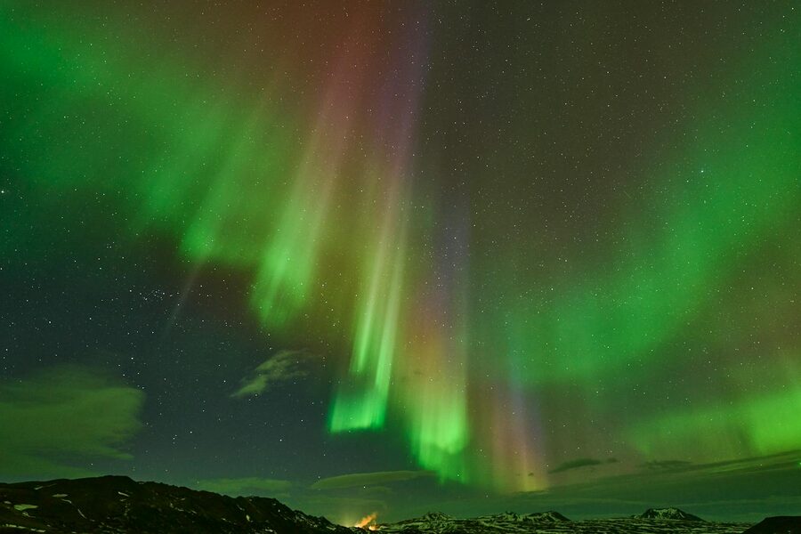 Bright green aurora borealis dancing over Iceland at night
