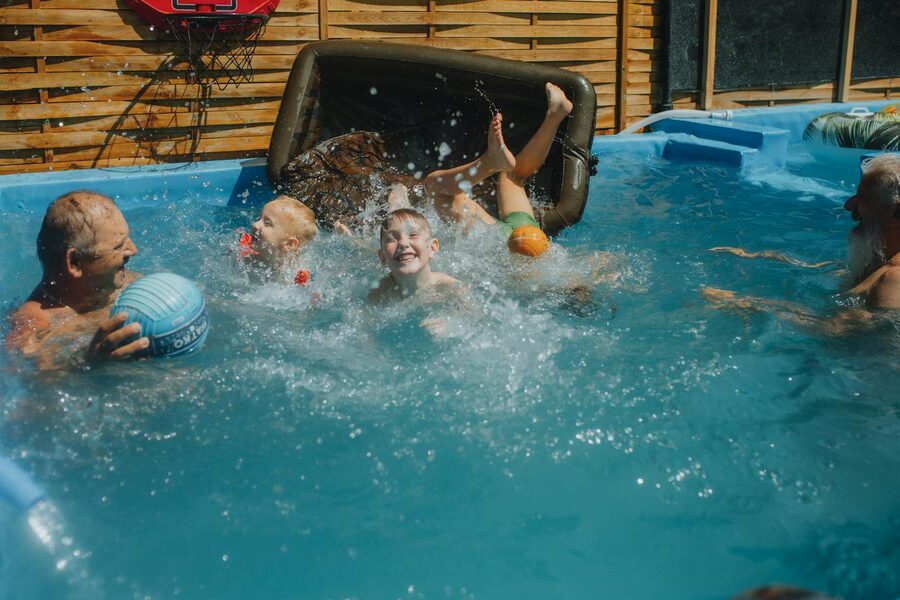 Family enjoying a sunny day in an outdoor swimming pool