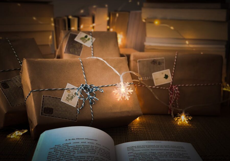 Christmas gifts and an open book under fairy lights — Jólabókaflóð