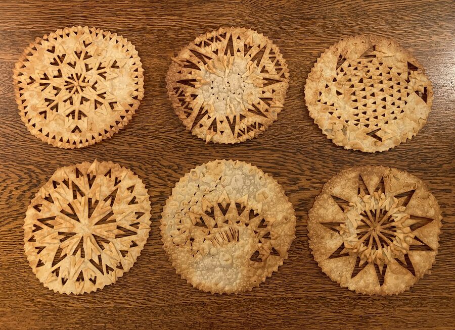 Laufabrauð decorated with intricate patterns before frying