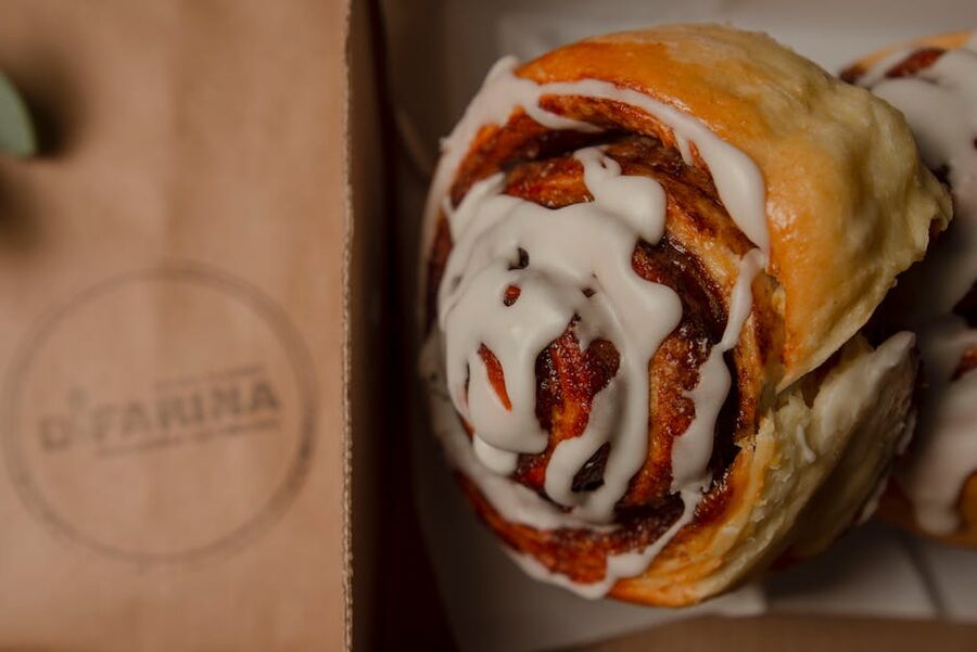 Iced cinnamon roll on a paper bag