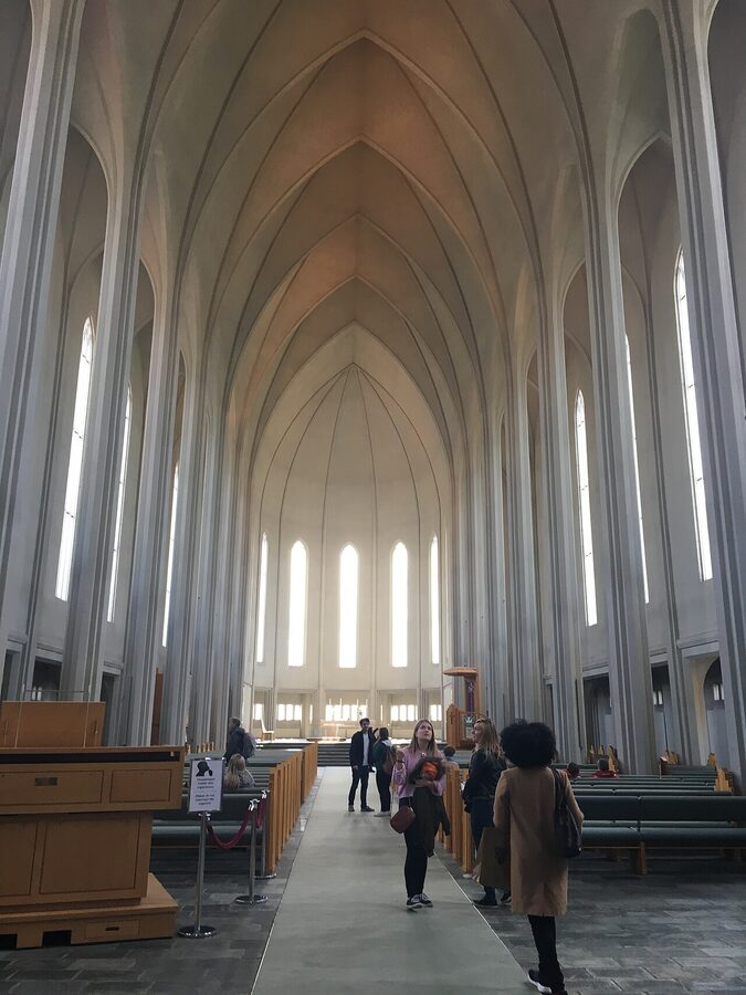 Inside Hallgrímskirkja church Reykjavik with white columns and arches