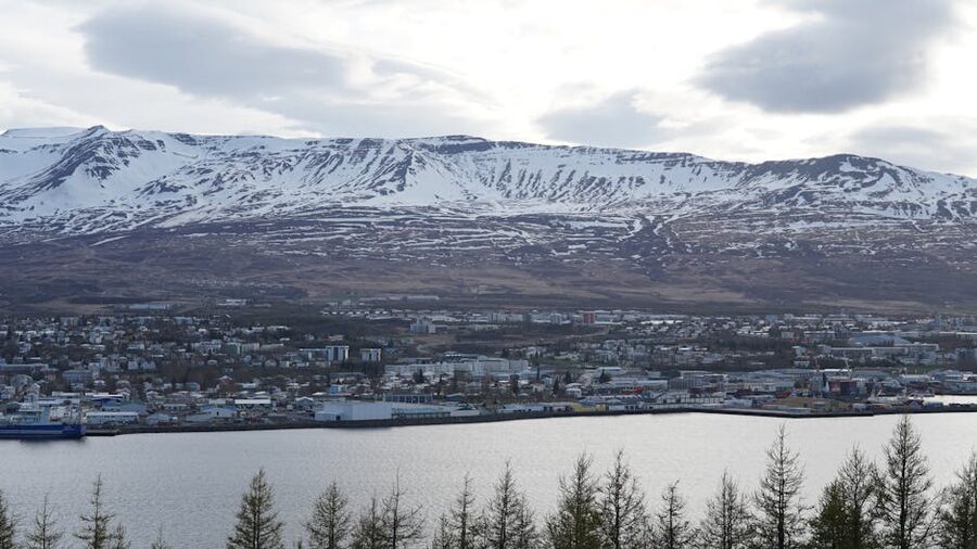 Akureyri Iceland with snowcapped mountains and a peaceful harbour