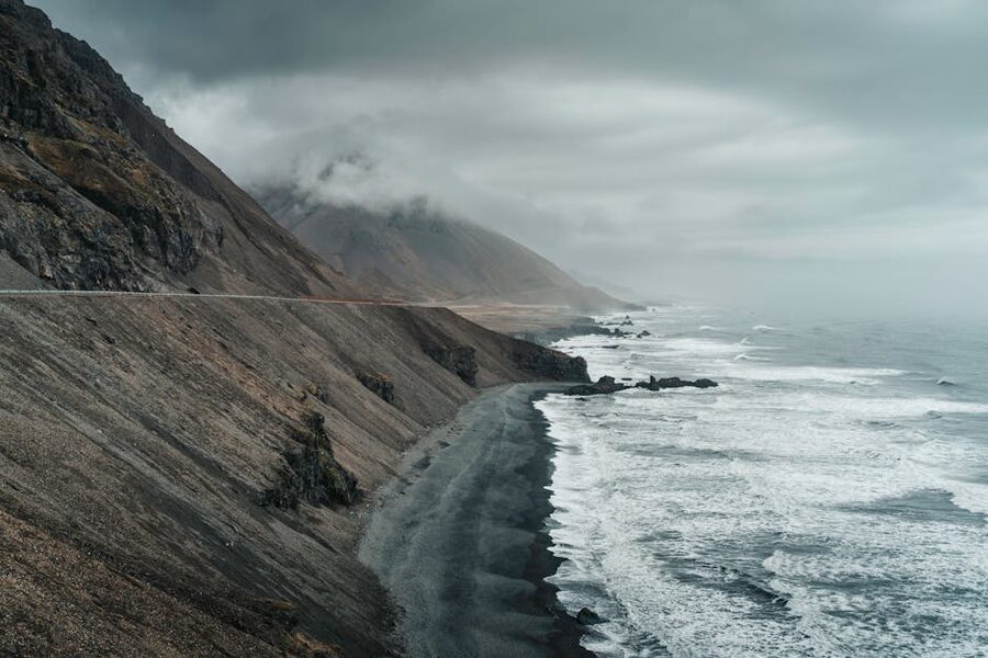 Iceland coastline with dark sand and surf under a moody sky