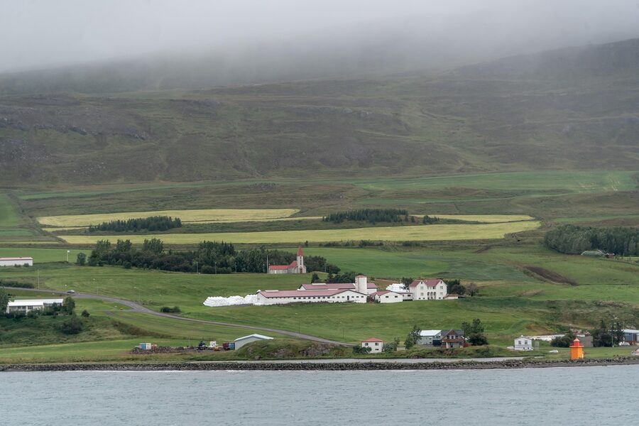 Fog and clouds over Akureyri Iceland with mountains and lighthouse