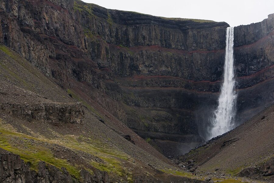 Hengifoss waterfall plunging into red basalt canyon East Iceland
