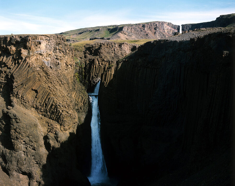 Litlanesfoss waterfall surrounded by basalt columns near Hengifoss