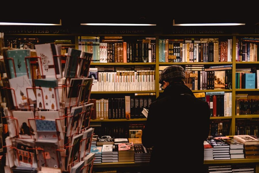 Person browsing books in a cosy bookstore