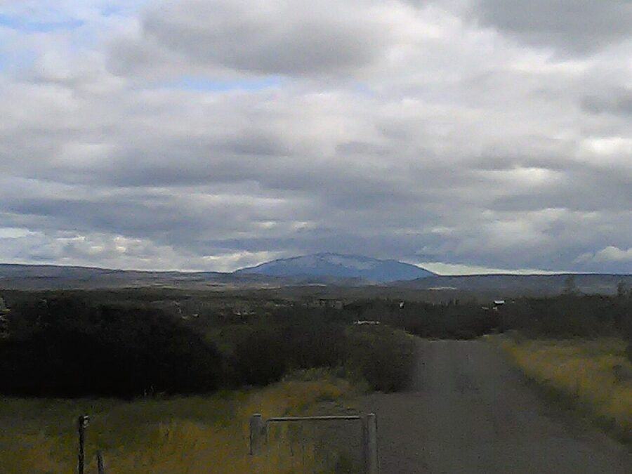 The volcano Hekla in southern Iceland viewed across summer fields