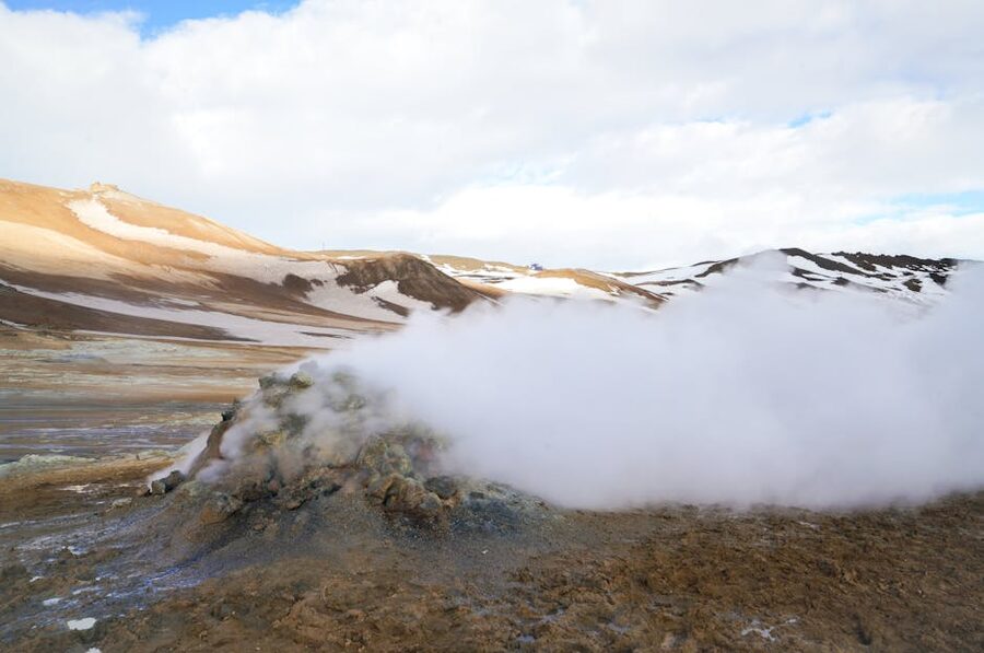 Steam rising from a geothermal vent in Iceland's rugged landscape