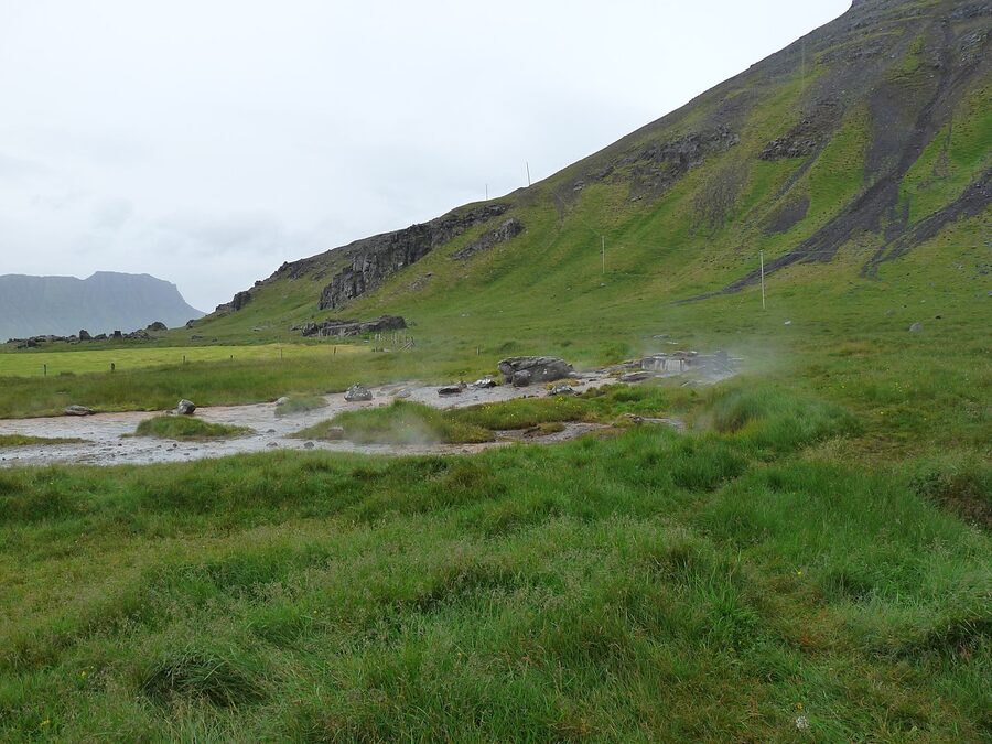 Krossnes hot spring pool with the Atlantic Ocean and cliffs behind
