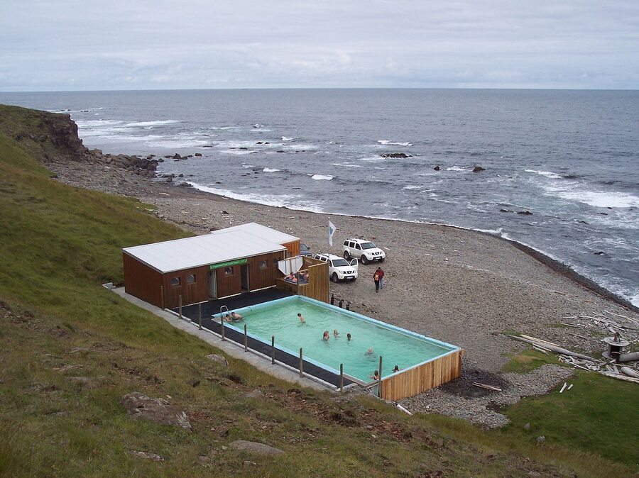 The Krossneslaug concrete swimming pool on the rocky beach in Strandir Westfjords