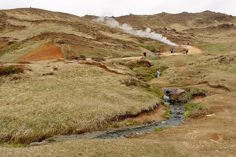 The hiking trail leading into Reykjadalur Valley with steaming hillsides