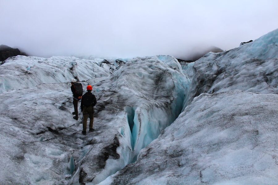 Two adventurers exploring an Icelandic glacier