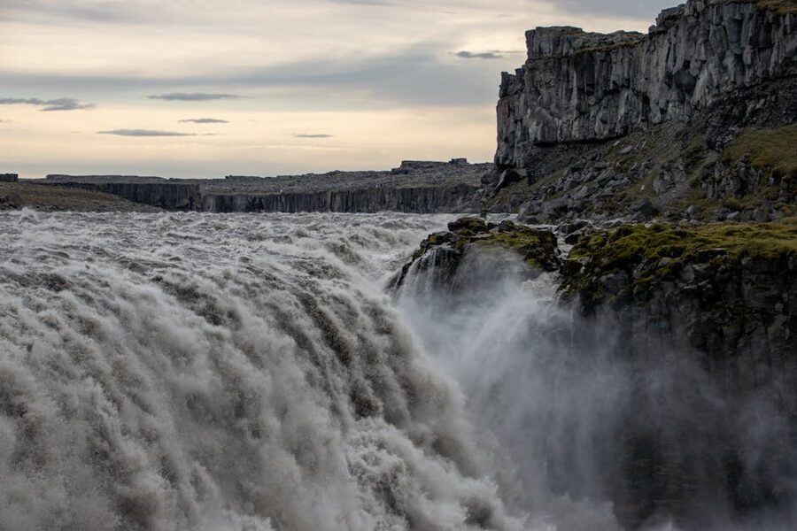 Powerful flow of Dettifoss waterfall over rugged cliffs in Iceland