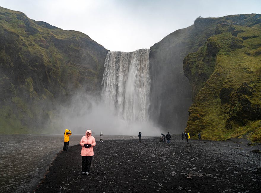 Visitors looking at Skogafoss waterfall in south Iceland
