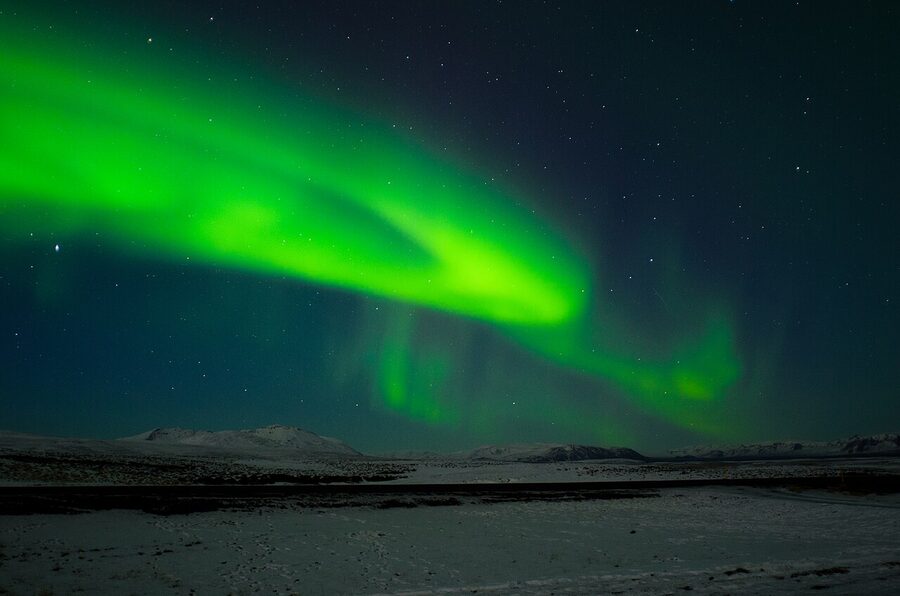 Soft KP3 aurora glow over a rural Iceland field