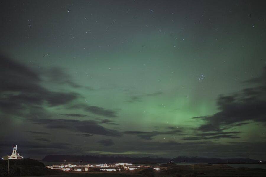 Wide aurora display over an Iceland landscape on a clear winter night