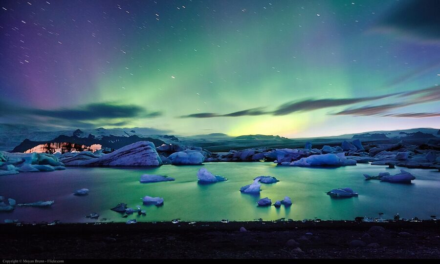 Vivid storm-level aurora curtains hanging over an Iceland landscape