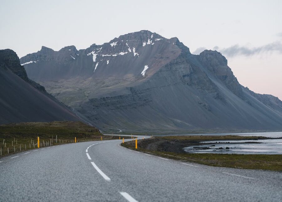 A quiet Icelandic mountain road winding through the countryside