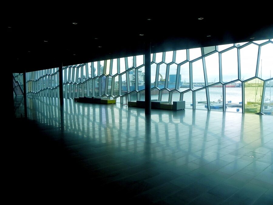Harpa concert hall in Reykjavik with glass facade reflecting the harbour