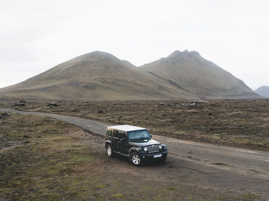 A 4x4 vehicle traversing remote gravel roads in the Iceland highlands