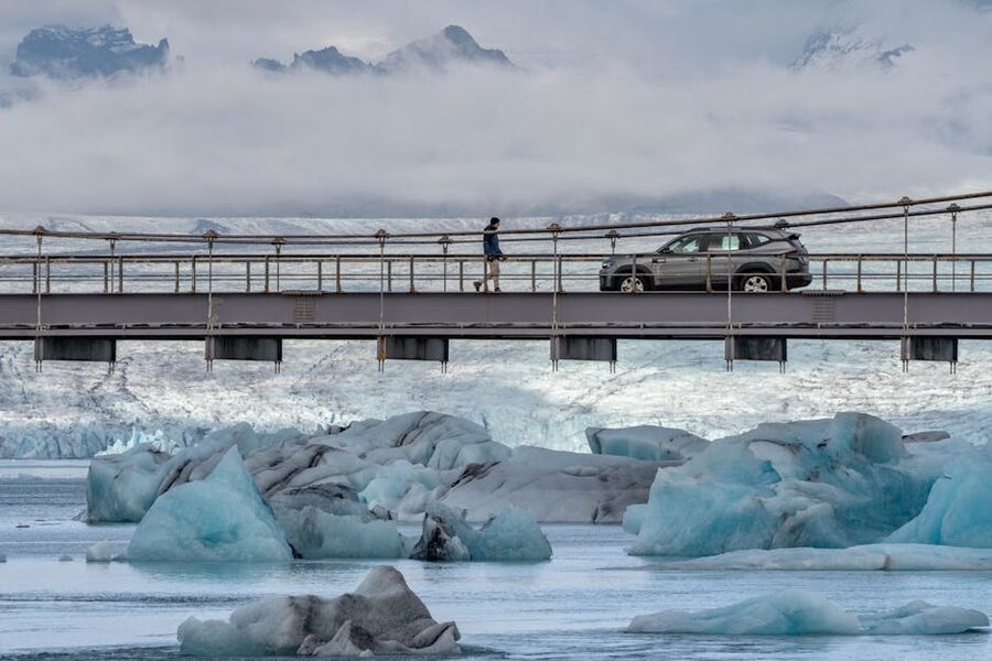 Car on a bridge over an icy glacial lagoon in Iceland