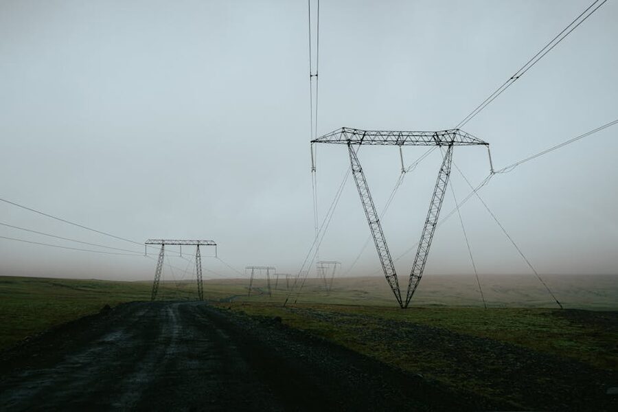 Power lines stretch across a misty Iceland landscape