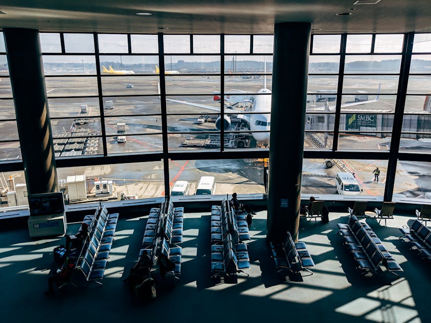 Airport terminal with view of tarmac and parked airplanes through windows