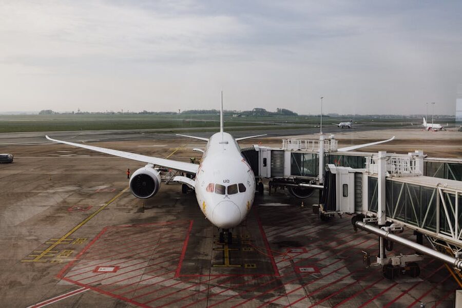 Jet airplane docked at airport terminal gate ready for boarding
