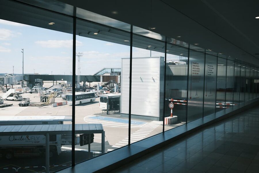 Modern airport terminal hallway with view of tarmac and parked airplanes