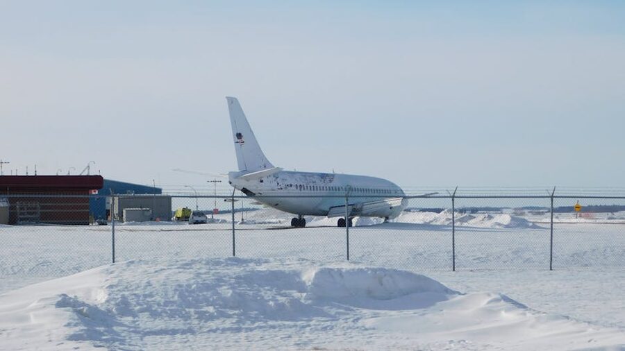 Airplane parked on a snowy runway in winter at the airport