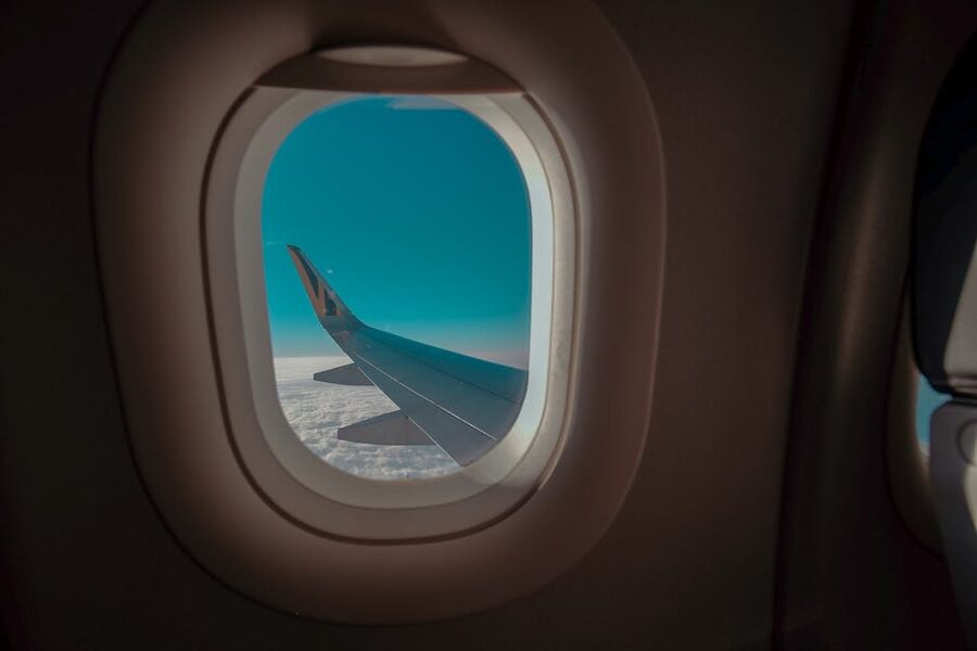 View from airplane window above the clouds during a long flight