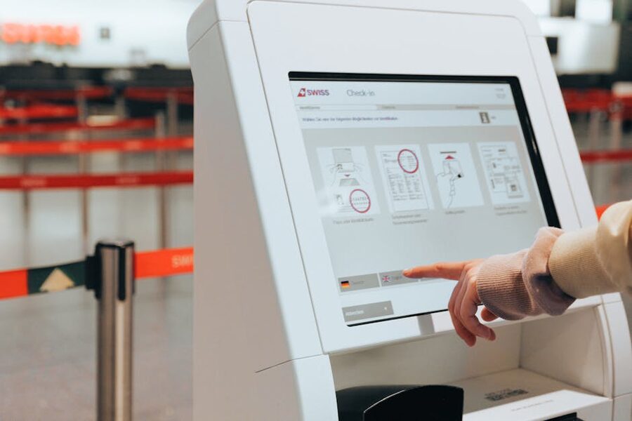 Passenger using a self-service check-in kiosk at the airport