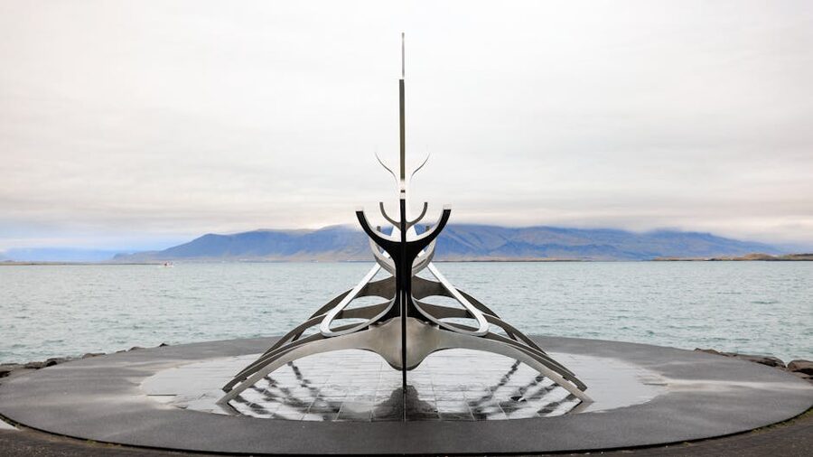 Sun Voyager sculpture on the Reykjavik waterfront with mountains beyond