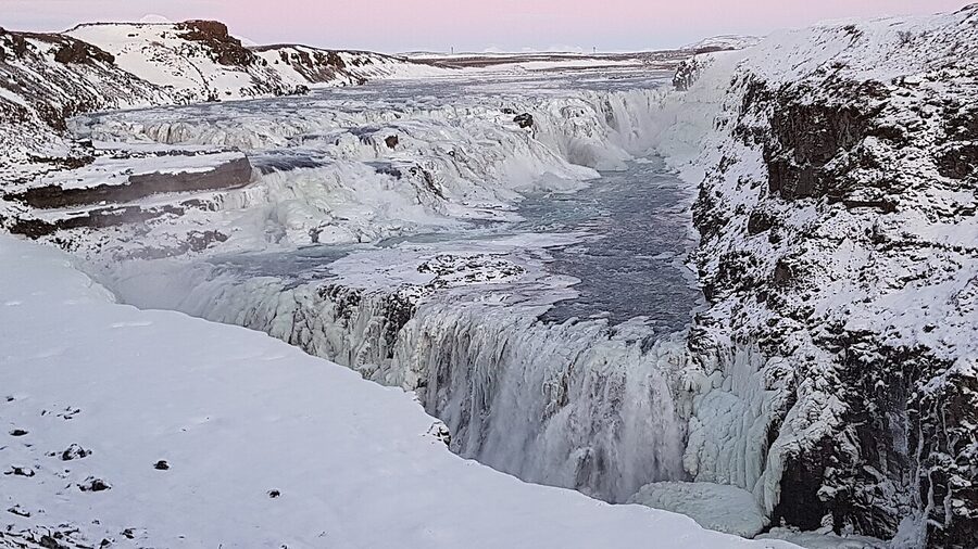 Gullfoss waterfall partially frozen in winter Iceland
