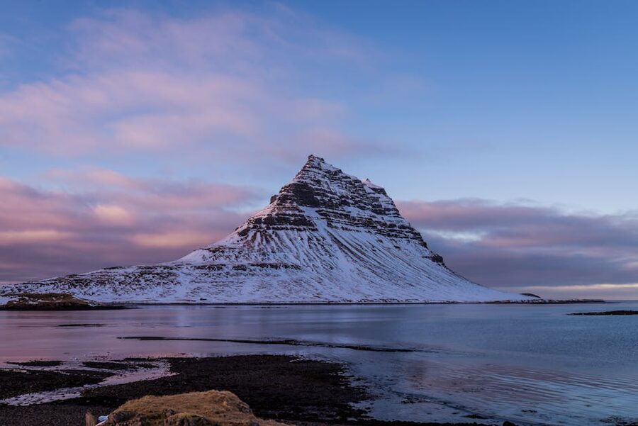Snow-covered Kirkjufell mountain in Iceland at dusk