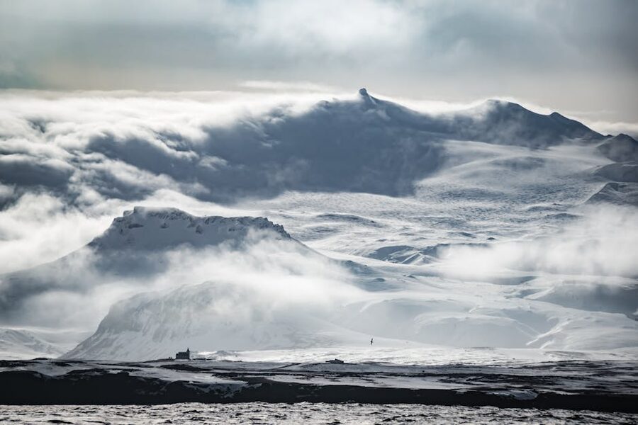 Snow-covered Icelandic mountains shrouded in fog in winter