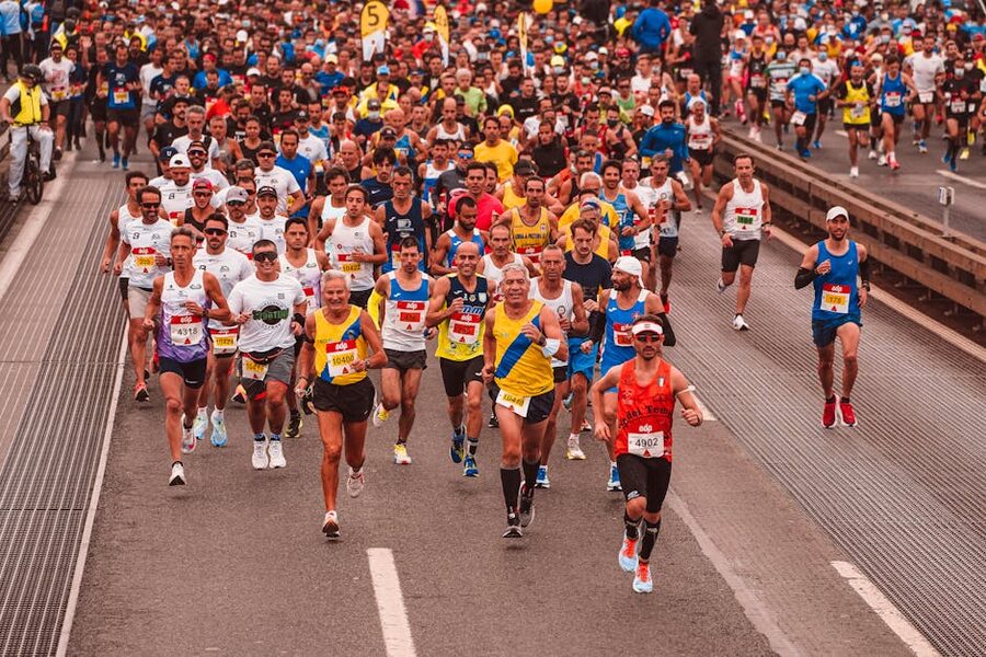 Group of athletes running a marathon on a road