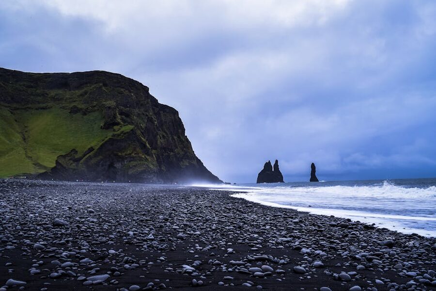Reynisfjara black sand beach with basalt sea stacks at golden hour