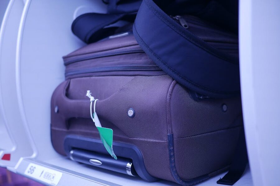 Carry-on luggage in an overhead aircraft compartment