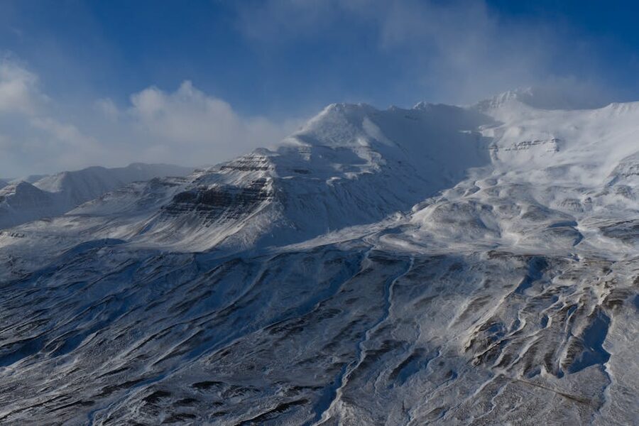 Snowy Iceland mountains showing the conditions that defeat impractical clothing