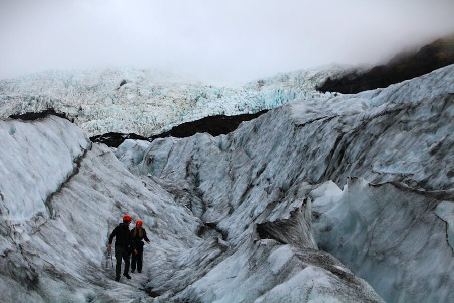 Glacier hiking gear arranged on a snowy slope in Iceland