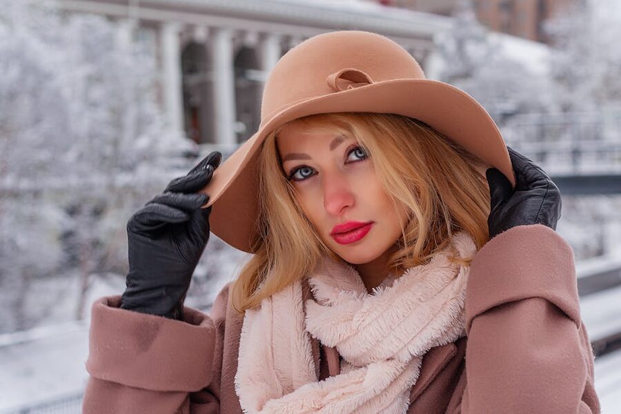 Woman in winter hat and gloves outdoors in cold weather