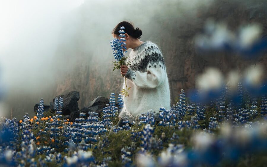 Person in an Icelandic lopapeysa wool sweater in a misty field